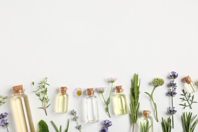 Photo of Essential oils and different plants on white background, flat lay. Space for text