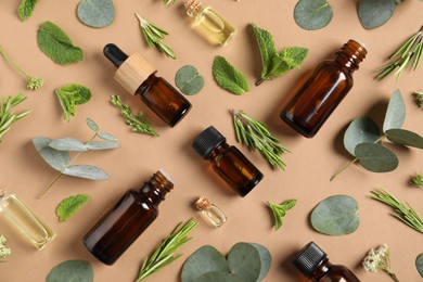 Photo of Essential oils and different plants on brown background, flat lay