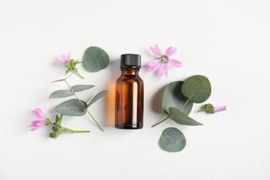Photo of Essential oil and different plants on white background, flat lay