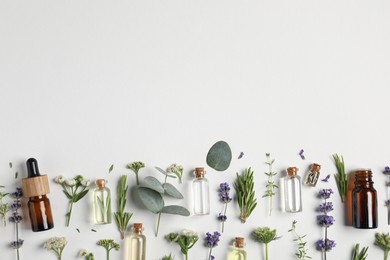 Photo of Essential oils and different plants on white background, flat lay. Space for text
