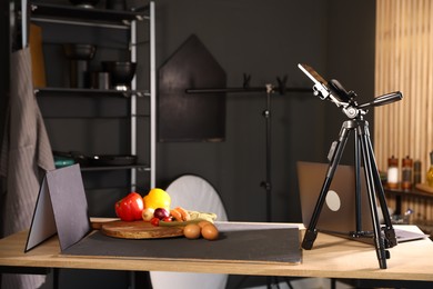 Photo of Shooting vegetables with smartphone in studio. Professional food photography