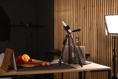 Photo of Shooting vegetables with smartphone in studio. Professional food photography