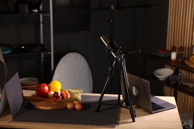 Photo of Shooting vegetables with smartphone in studio. Professional food photography
