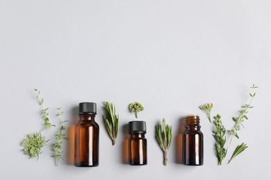 Photo of Essential oils and different plants on white background, flat lay. Space for text