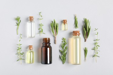 Photo of Essential oils and different plants on white background, flat lay