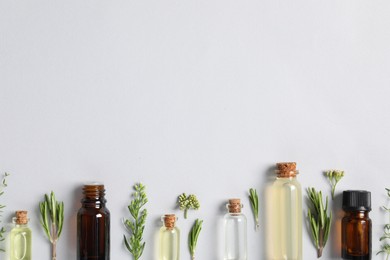 Photo of Essential oils and different plants on white background, flat lay. Space for text