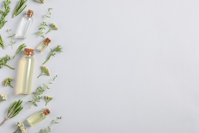 Photo of Essential oils and different plants on white background, flat lay. Space for text