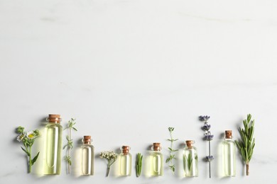 Photo of Essential oils and different plants on white background, flat lay. Space for text