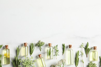 Photo of Essential oils and different plants on white background, flat lay. Space for text