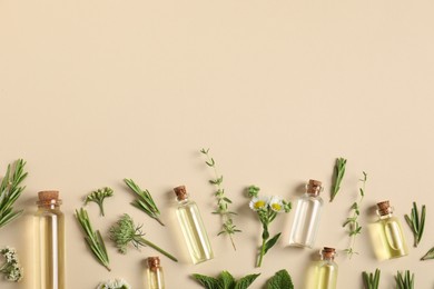 Photo of Essential oils and different plants on beige background, flat lay. Space for text