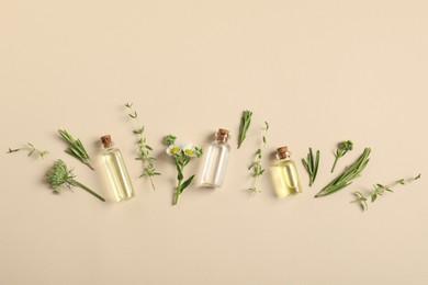 Photo of Essential oils and different plants on beige background, flat lay