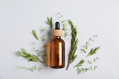 Photo of Essential oil and different plants on white background, flat lay
