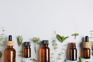 Photo of Essential oils and different plants on white background, flat lay. Space for text