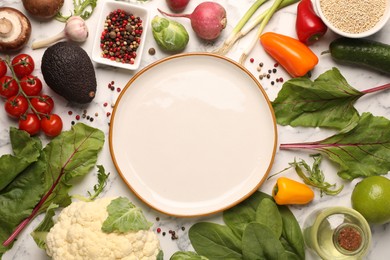 Photo of Healthy vegetarian food. Empty plate surrounded by different products on white marble table, flat lay