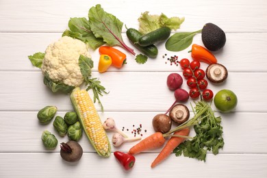 Photo of Healthy vegetarian food. Frame of different products on white wooden table, flat lay. Space for text