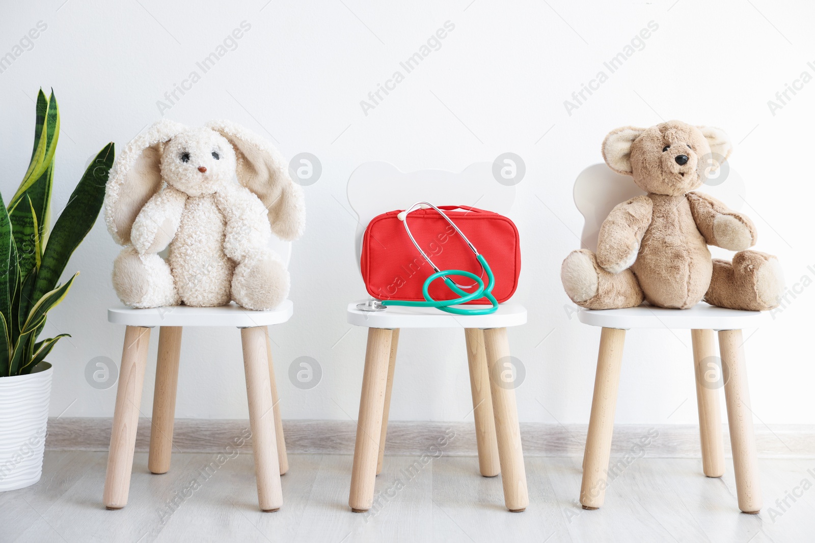 Photo of Pediatrician concept. Toys, medical bag and stethoscope on chairs in clinic
