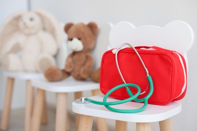 Photo of Pediatrician concept. Toys, medical bag and stethoscope on chairs in clinic, selective focus