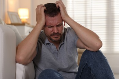 Photo of Man suffering from panic attack at home