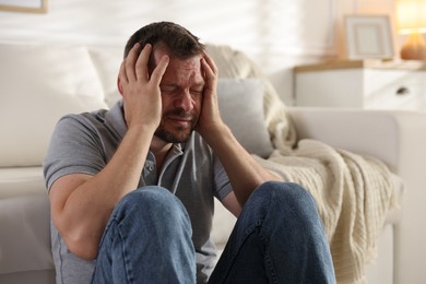 Photo of Man suffering from panic attack at home