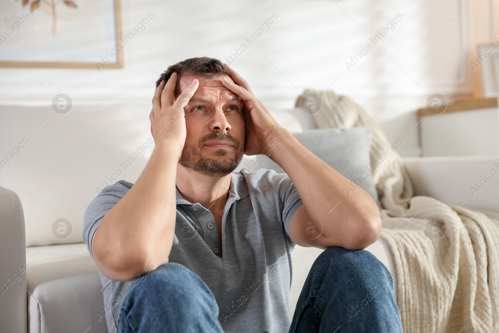 Man suffering from panic attack at home Photo of Man suffering from panic attack at home