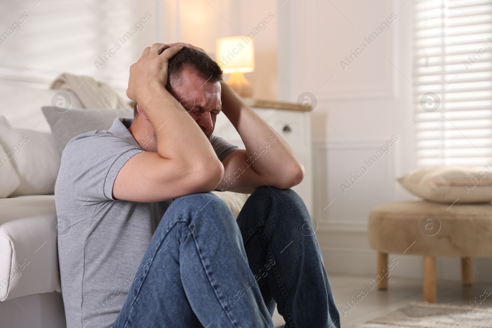 Man suffering from panic attack at home Photo of Man suffering from panic attack at home