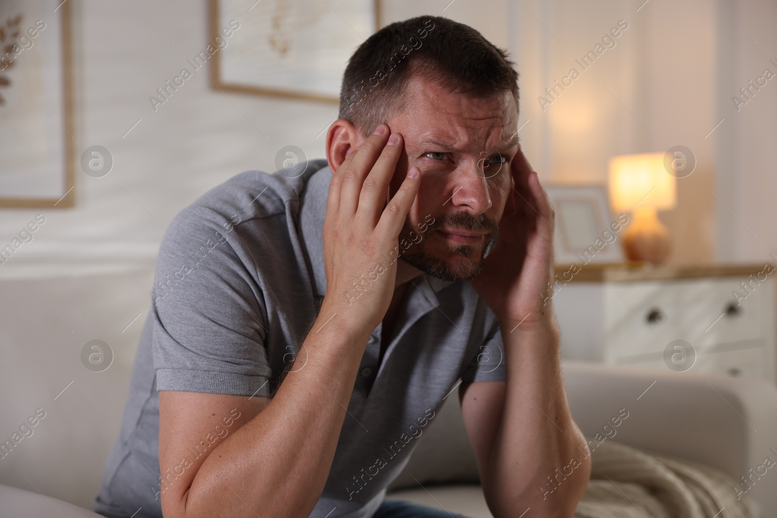 Man suffering from panic attack at home Photo of Man suffering from panic attack at home