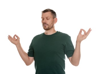 Photo of Panic attack. Man meditating to calm down on white background