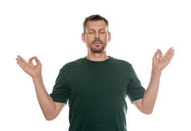Photo of Panic attack. Man meditating to calm down on white background