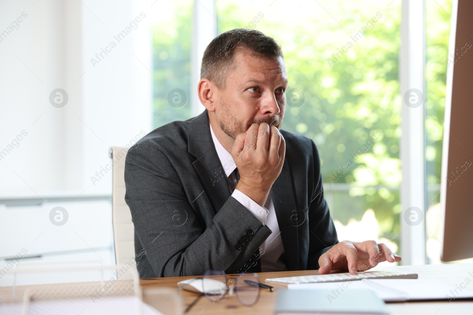 Businessman suffering from panic attack at workplace in office Photo of Businessman suffering from panic attack at workplace in office