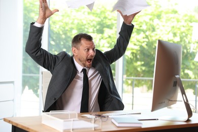 Photo of Businessman suffering from panic attack at workplace in office