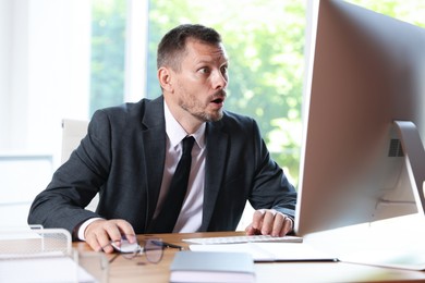 Photo of Businessman suffering from panic attack at workplace in office