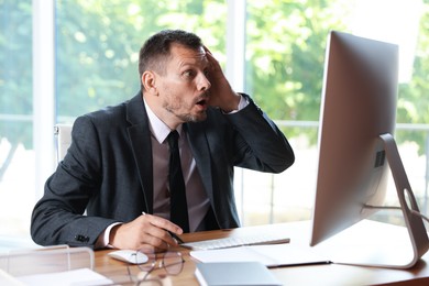 Photo of Businessman suffering from panic attack at workplace in office