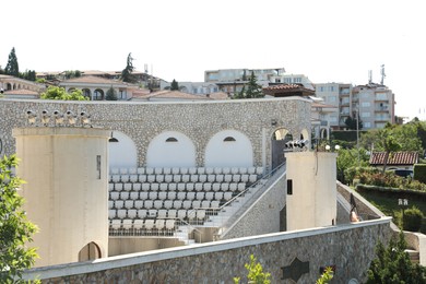 Photo of Sveti Vlas, Bulgaria - July 13, 2025: Open air amphitheatre Arena, buildings and green trees