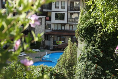 Photo of Sveti Vlas, Bulgaria - July 13, 2025: Beautiful hotel with swimming pool and green plants