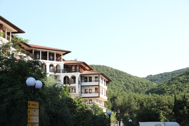Photo of Sveti Vlas, Bulgaria - July 13, 2025: Beautiful hotel and green mountains, low angle view