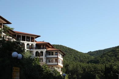 Photo of Sveti Vlas, Bulgaria - July 13, 2025: Beautiful hotel and green mountains, low angle view