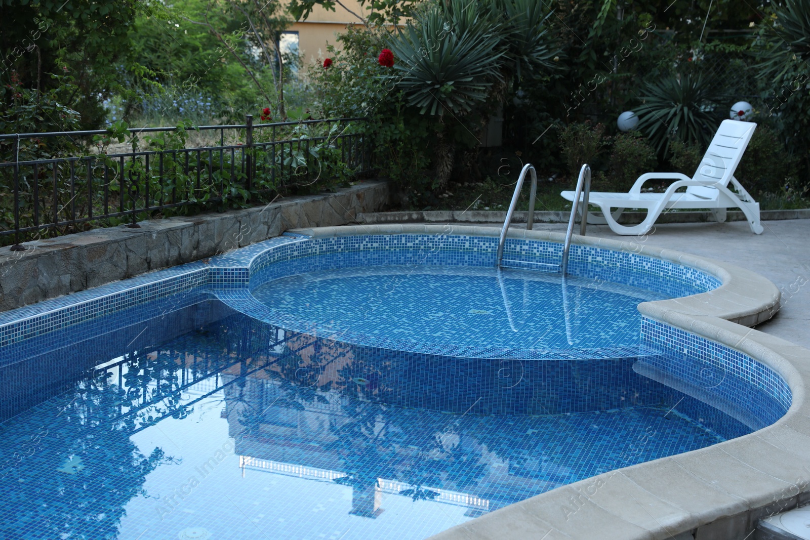 Photo of Outdoor swimming pool and different green plants