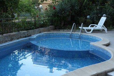 Photo of Outdoor swimming pool and different green plants