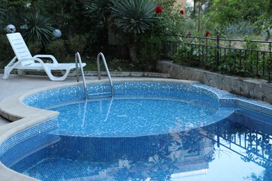 Photo of Outdoor swimming pool and different green plants