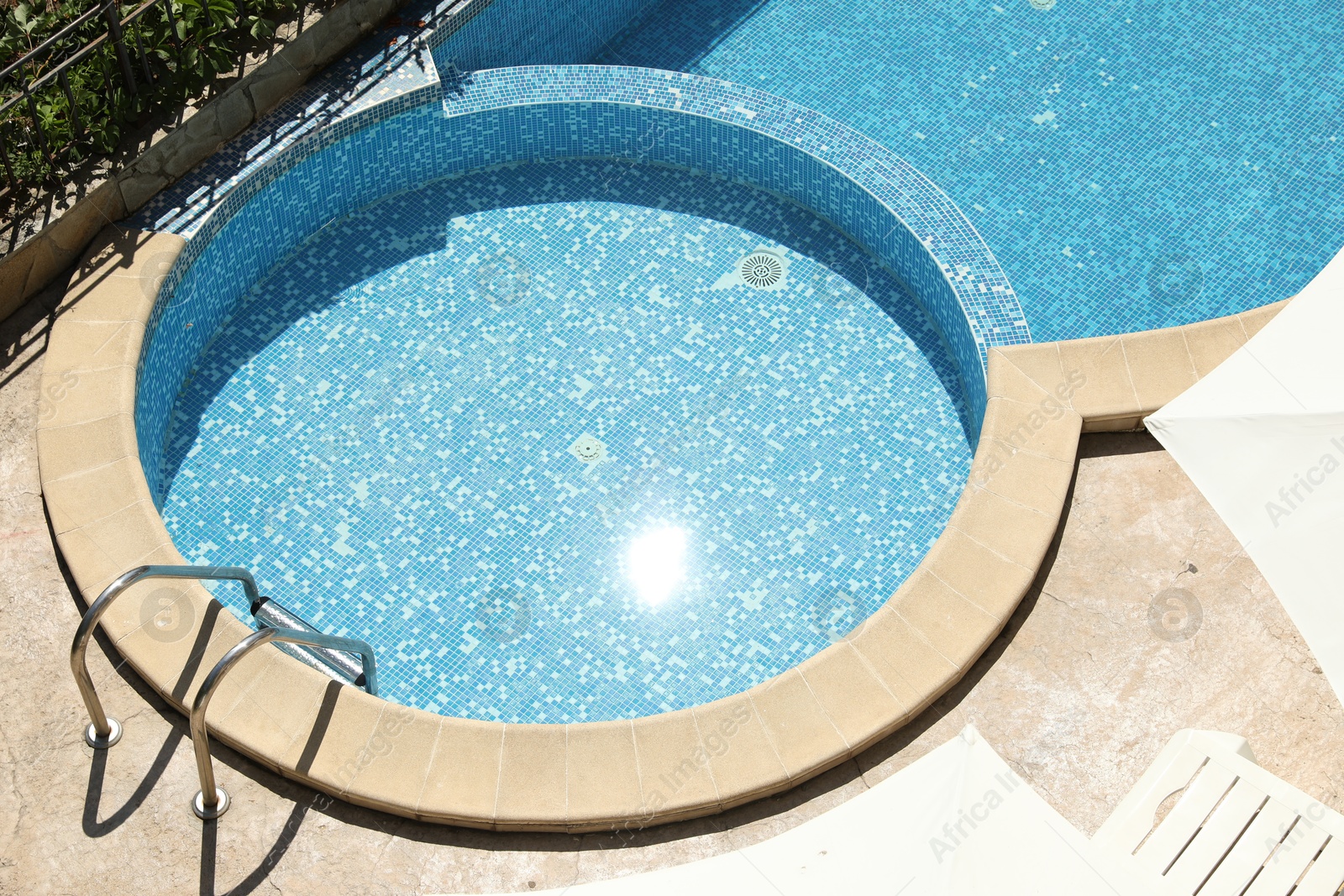 Photo of Beautiful outdoor swimming pool with ladder on sunny day, above view