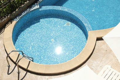 Photo of Beautiful outdoor swimming pool with ladder on sunny day, above view