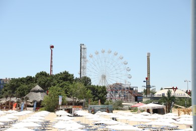 Photo of Sveti Vlas, Bulgaria - July 12, 2025: View of beach with umbrellas and Ferris wheel