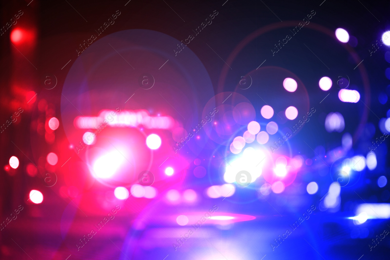 Image of Police red and blue lights in city at night, blurred view
