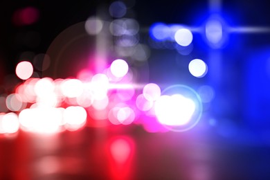 Image of Police red and blue lights in city at night, blurred view