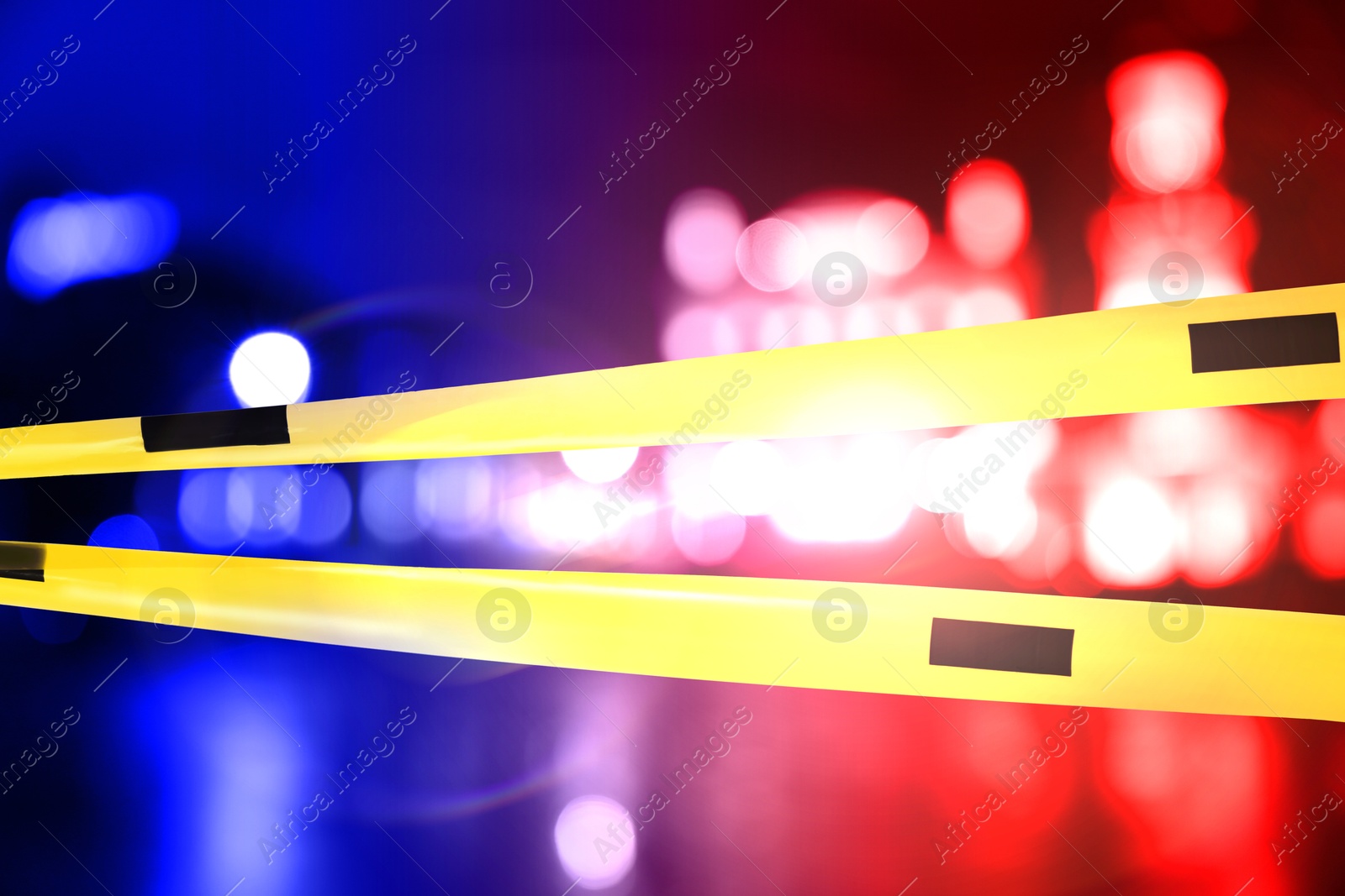Image of Police red and blue lights and yellow Crime Scene Do Not Cross tape