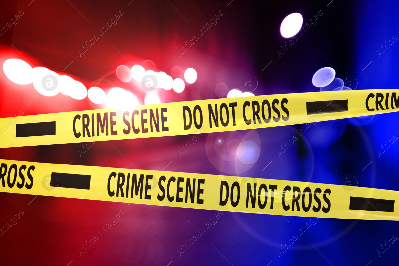 Image of Police red and blue lights and yellow Crime Scene Do Not Cross tape
