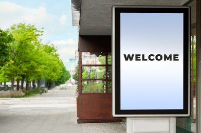 Image of Advertising board with word Welcome near restaurant outdoors