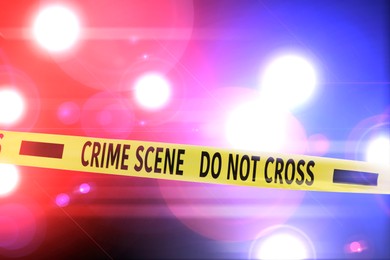 Image of Police red and blue lights and yellow Crime Scene Do Not Cross tape