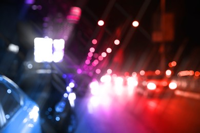 Image of Police red and blue lights in city at night, blurred view