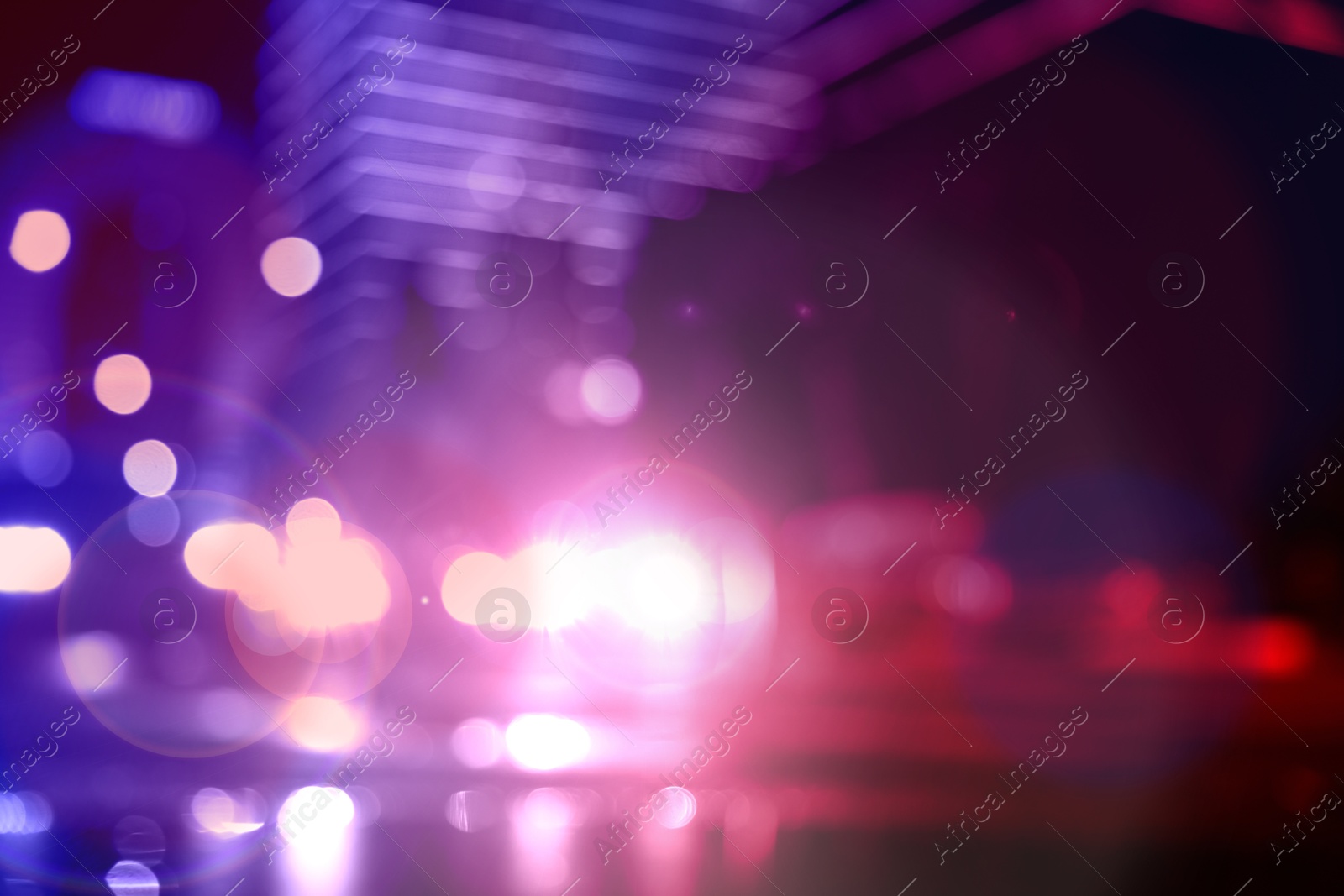 Image of Police red and blue lights in city at night, blurred view